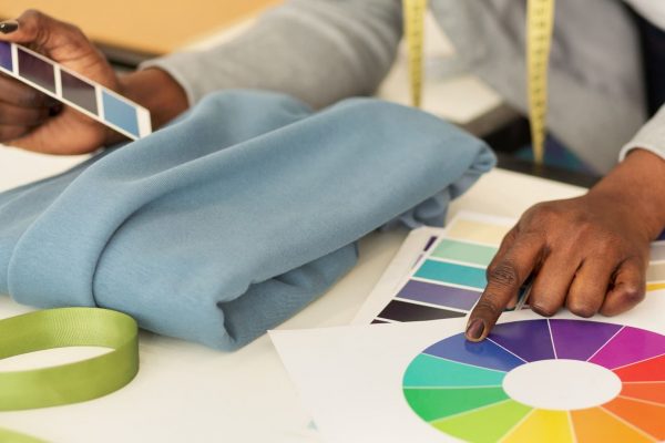 Female Designer Working With Fabric And Color Samples, Closeup